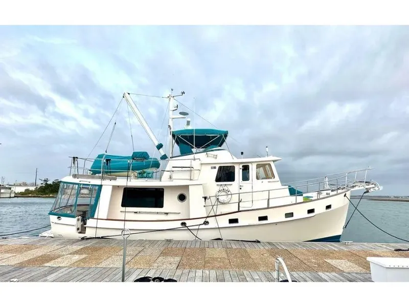 Slide: The Image of Kadey-Krogen 44AE 2019 yacht docked by the waterfront under cloudy skies. - 9