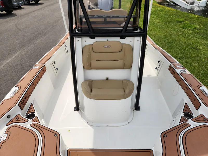 Slide: The Image of 2017 Sea Hunt BX 25 BR boat interior with tan seating and white deck. - 10