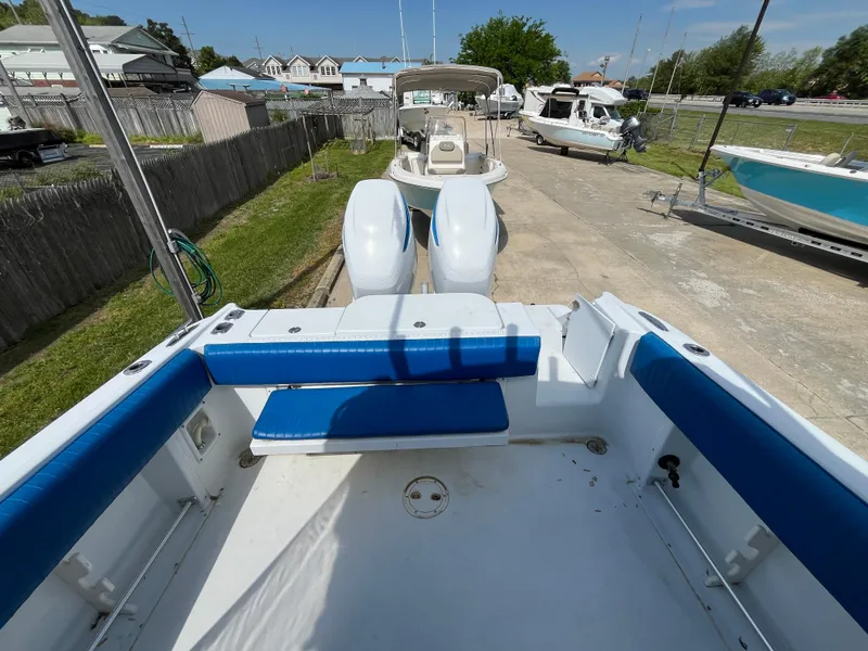 Slide: The Image of 2000 Hydra-Sports 2796 Vector boat with blue seating, docked outdoors. - 10