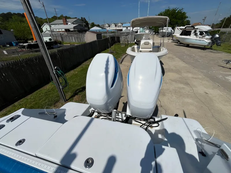 Slide: The Image of 2000 Hydra-Sports 2796 Vector boat with dual outboard engines, parked in a residential area. - 5