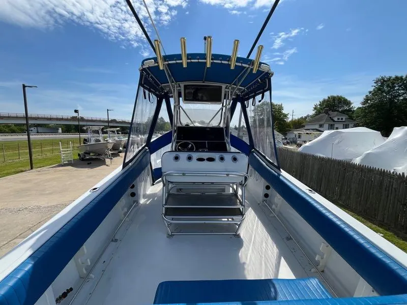 Slide: The Image of 2000 Hydra-Sports 2796 Vector boat with blue seating and fishing rod holders. - 6