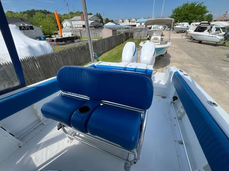 Slide: The Image of 2000 Hydra-Sports 2796 Vector boat with blue seating and dual outboard motors. - 9