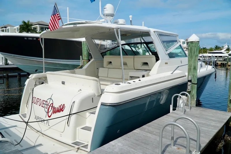 Slide: The Image of 1998 Tiara Yachts 4000 Express docked, featuring spacious seating and sleek design. - 10