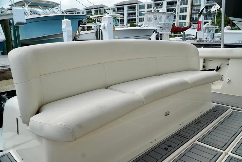 Slide: The Image of 1998 Tiara Yachts 4000 Express boat with white leather seating at a marina. - 19