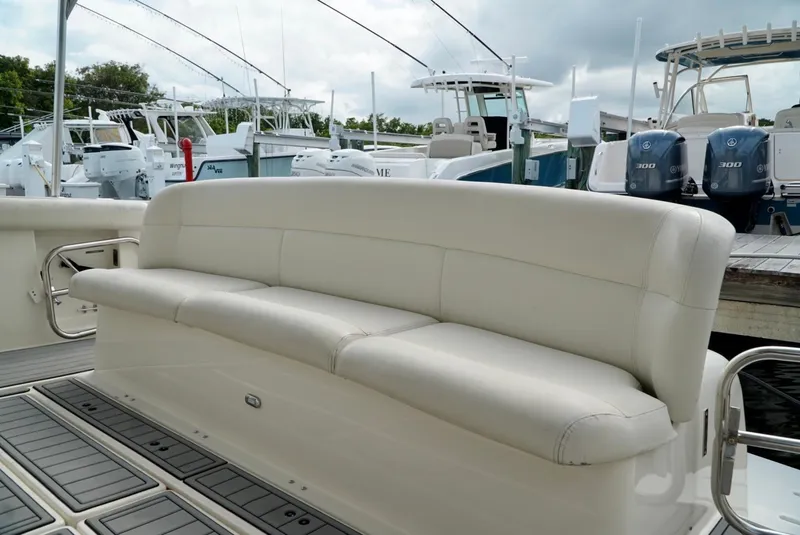Slide: The Image of 1998 Tiara Yachts 4000 Express boat with white leather seating at a marina. - 20