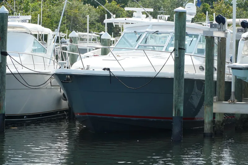 Slide: The Image of 1998 Tiara Yachts 4000 Express docked at marina, surrounded by other boats. - 23