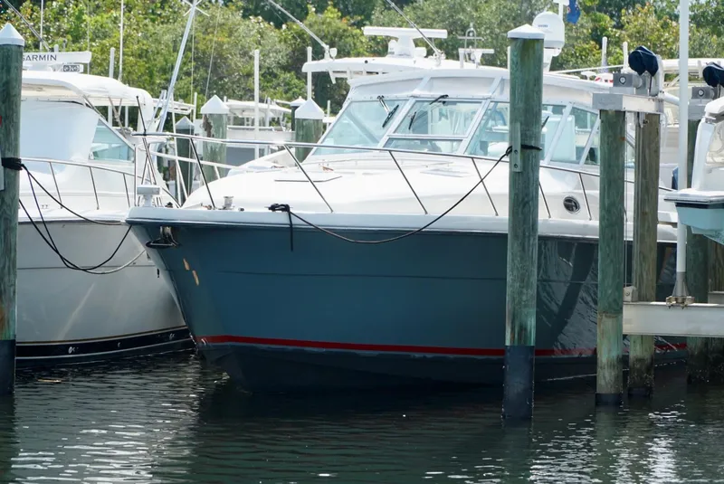 Slide: The Image of 1998 Tiara Yachts 4000 Express docked at marina, surrounded by other boats. - 24