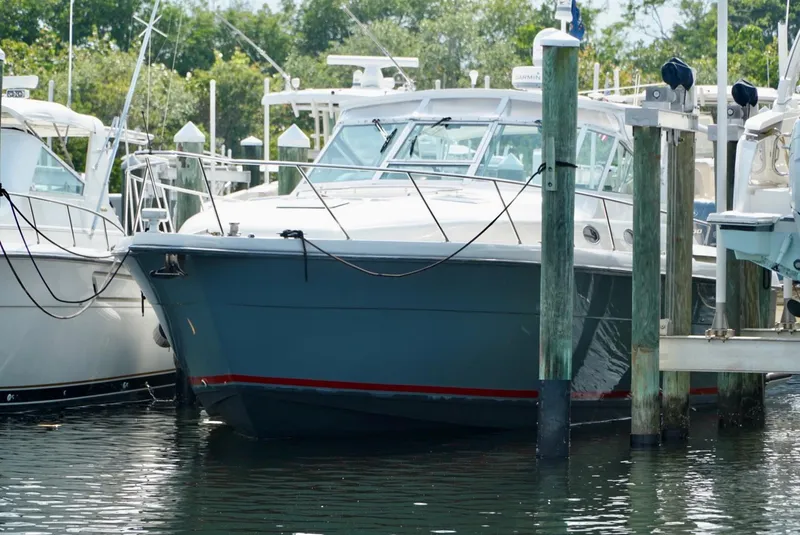 Slide: The Image of 1998 Tiara Yachts 4000 Express docked at marina, surrounded by other boats. - 25