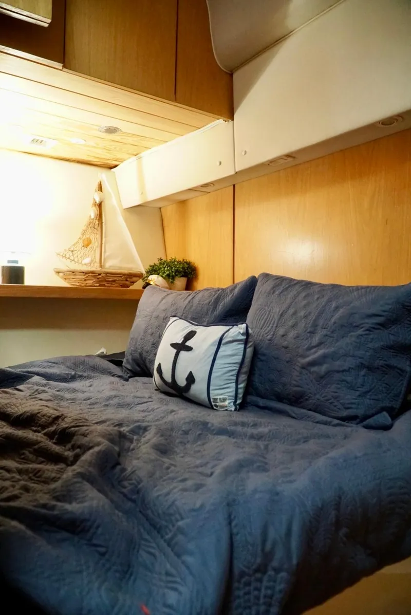 Slide: The Image of Cozy cabin interior of 1998 Tiara Yachts 4000 Express with nautical decor and plush bedding. - 26