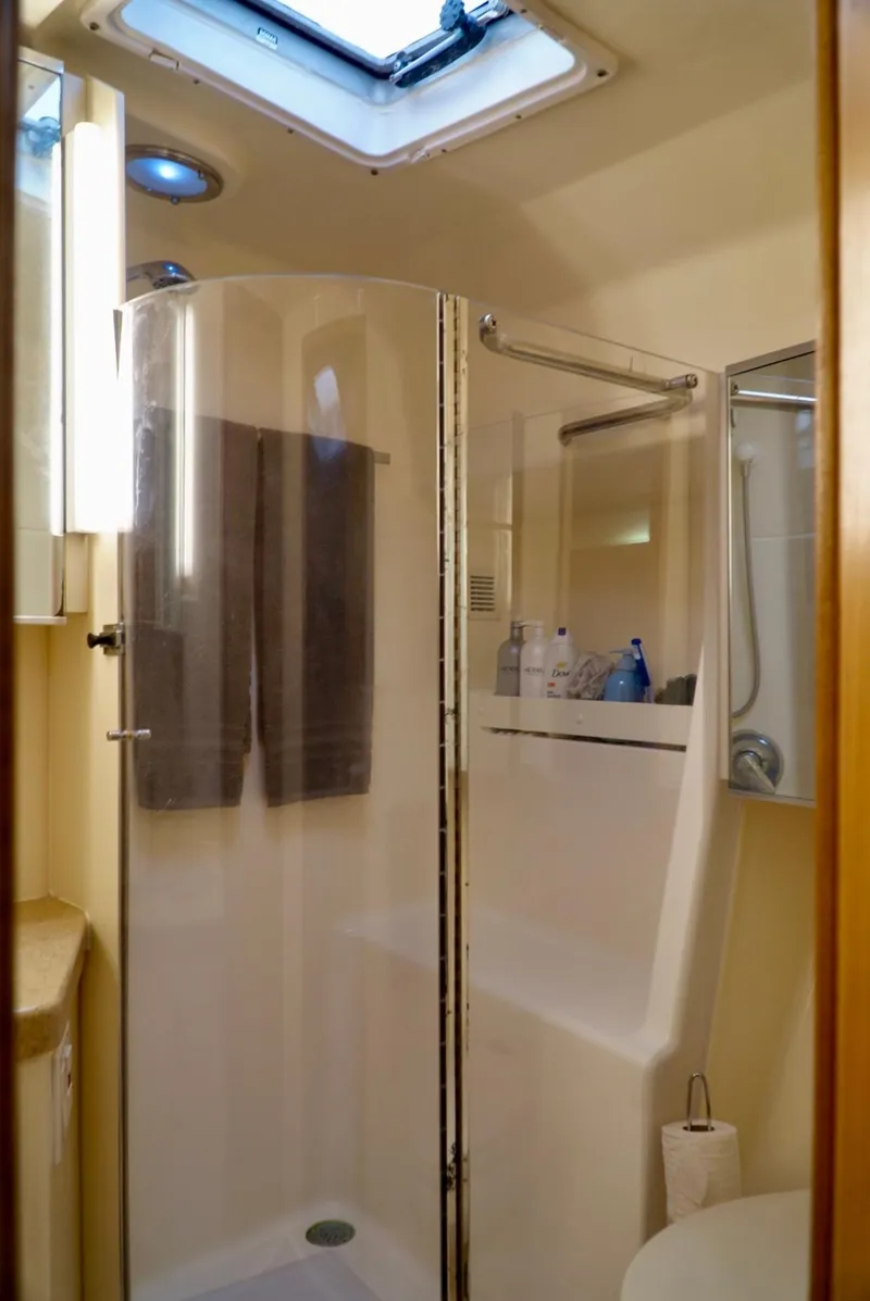 Slide: The Image of 1998 Tiara Yachts 4000 Express bathroom with shower, skylight, and modern amenities. - 27
