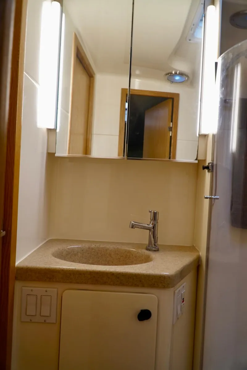 Slide: The Image of 1998 Tiara Yachts 4000 Express bathroom with sink, mirror, and modern lighting. - 28