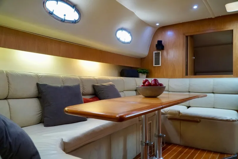 Slide: The Image of Luxurious interior of 1998 Tiara Yachts 4000 Express with plush seating and elegant table. - 29