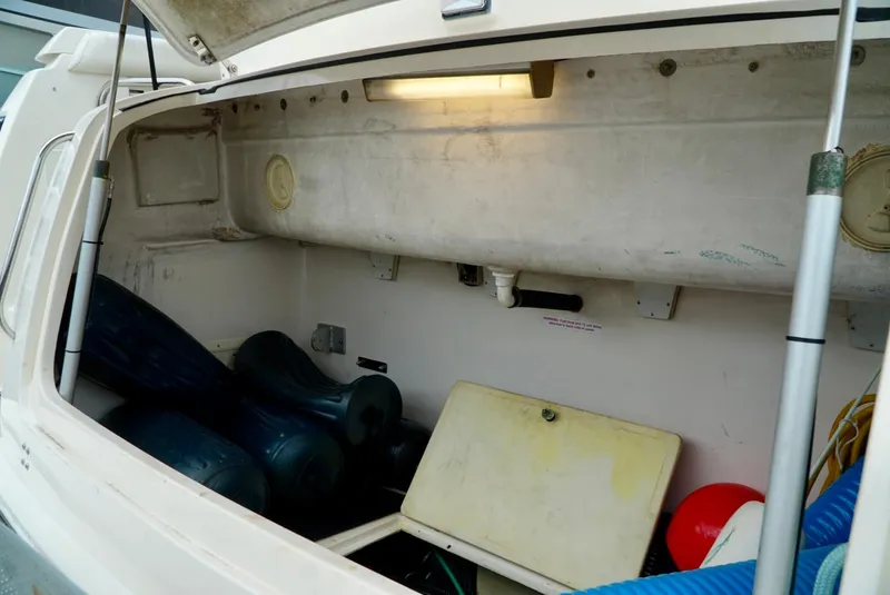 Slide: The Image of 1998 Tiara Yachts 4000 Express storage compartment with various boating equipment and accessories. - 32