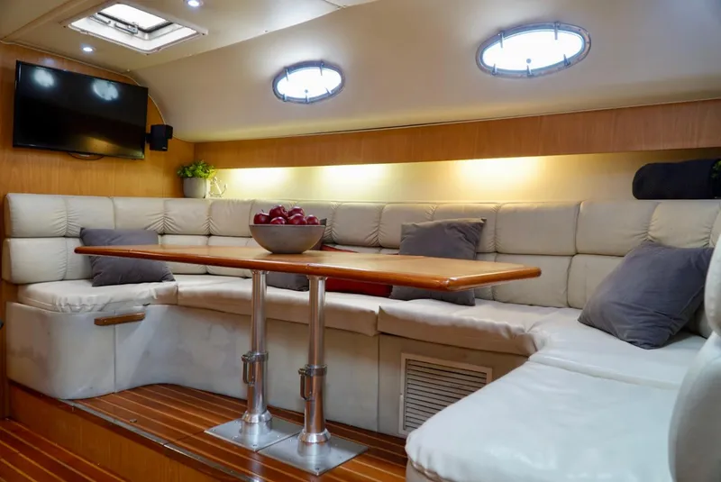 Slide: The Image of Luxurious 1998 Tiara Yachts 4000 Express interior with plush seating and elegant wooden table. - 36