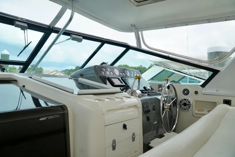 Slide: The Image of Interior view of 1998 Tiara Yachts 4000 Express helm with steering wheel and controls. - 39