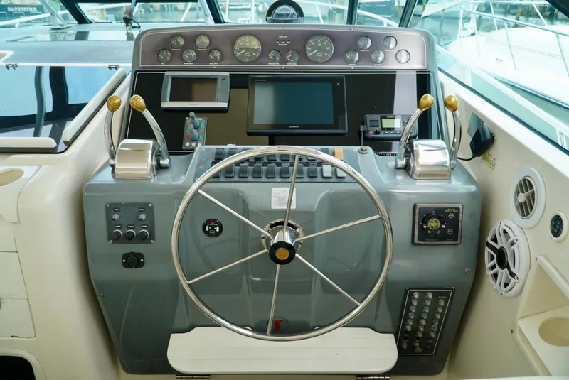 Slide: The Image of 1998 Tiara Yachts 4000 Express helm with steering wheel and control panel. - 42