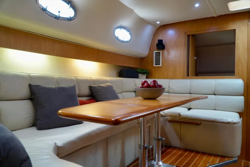 Slide: The Image of Luxurious interior of 1998 Tiara Yachts 4000 Express with plush seating and wooden table. - 44