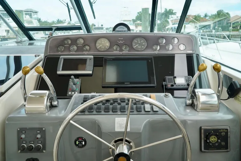 Slide: The Image of 1998 Tiara Yachts 4000 Express helm with steering wheel and navigation instruments. - 45