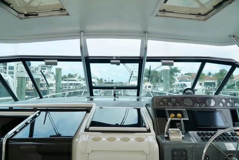 Slide: The Image of 1998 Tiara Yachts 4000 Express helm with modern controls and marina view. - 46