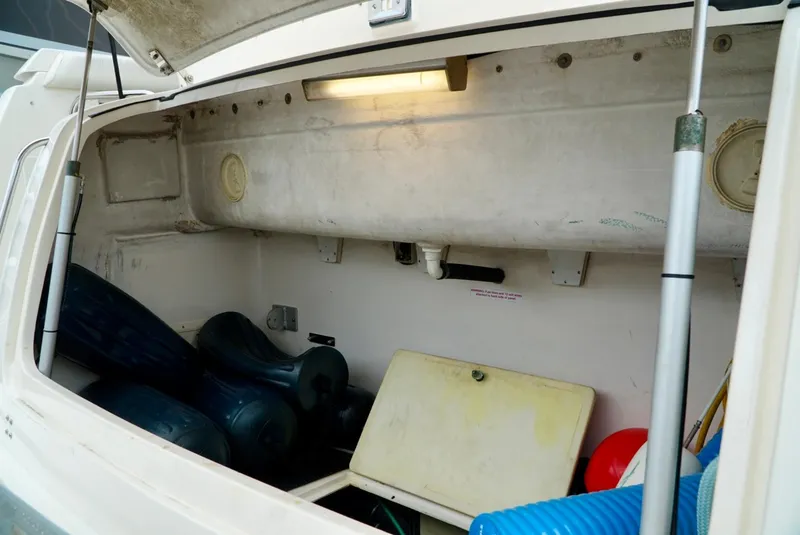 Slide: The Image of Storage compartment of a 1998 Tiara Yachts 4000 Express, featuring various boating equipment. - 47