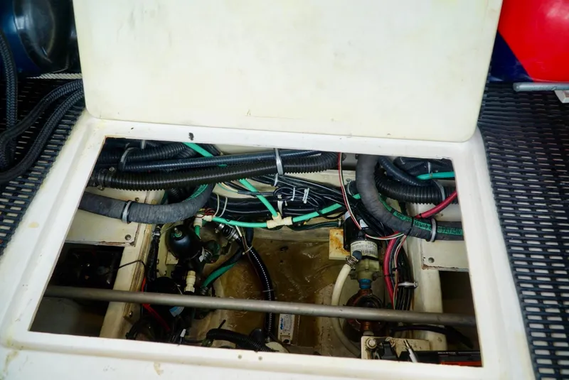 Slide: The Image of Engine compartment of a 1998 Tiara Yachts 4000 Express, showing wiring and hoses. - 48
