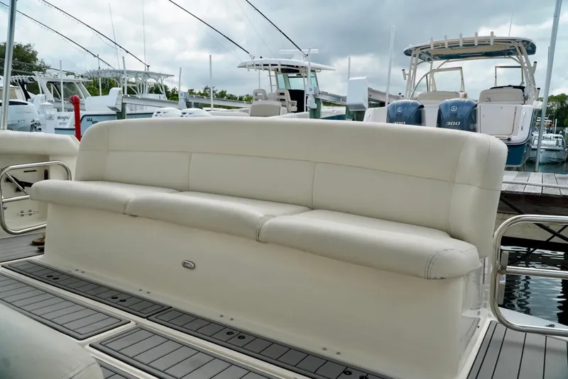 Slide: The Image of 1998 Tiara Yachts 4000 Express with beige seating, docked at a marina. - 7
