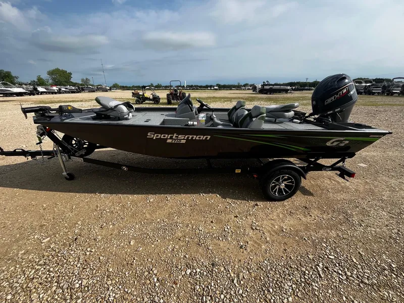 Slide: The Image of 2025 G3 Sportsman 1710 PFX boat on trailer, parked on gravel lot. - 4