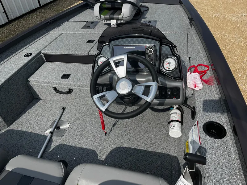 Slide: The Image of 2025 G3 Sportsman 1710 PFX boat interior with steering wheel and dashboard controls. - 7