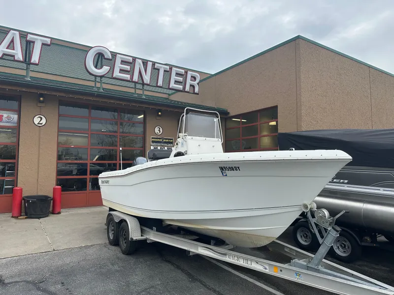 Slide: The Image of 2016 Clearwater 2200CC boat on trailer outside a boat center. - 0