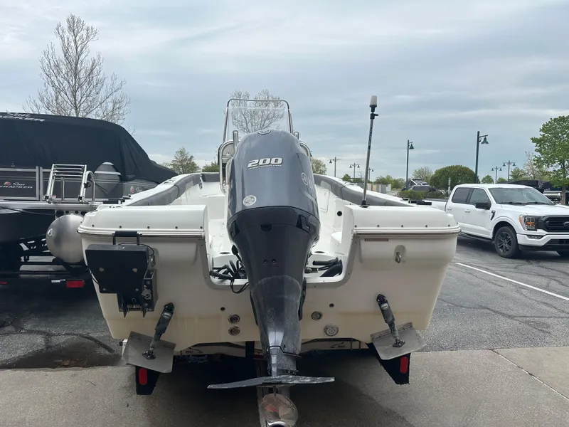 Slide: The Image of 2016 Clearwater 2200CC boat with 200HP engine, parked outdoors. - 4