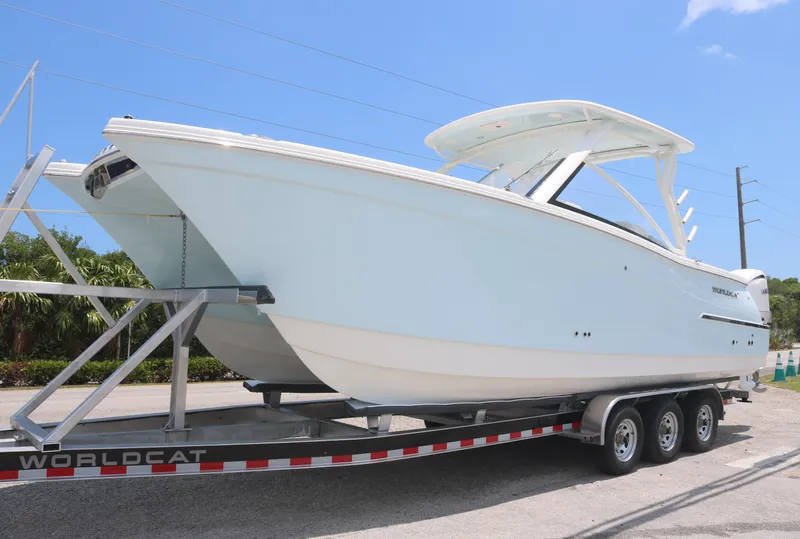 The Image of 2025 World Cat 280 DC boat on trailer under clear blue sky. - 0