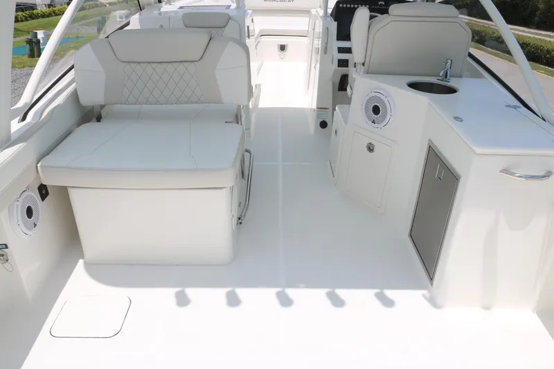 Slide: The Image of 2025 World Cat 280 DC boat interior with seating and kitchenette area. - 11