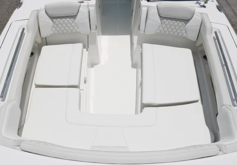 Slide: The Image of 2025 World Cat 280 DC boat interior with white cushioned seating and sleek design. - 7