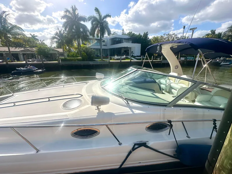 Slide: The Image of 2008 Sea Ray 420 Sundancer yacht docked by palm trees under a sunny sky. - 12