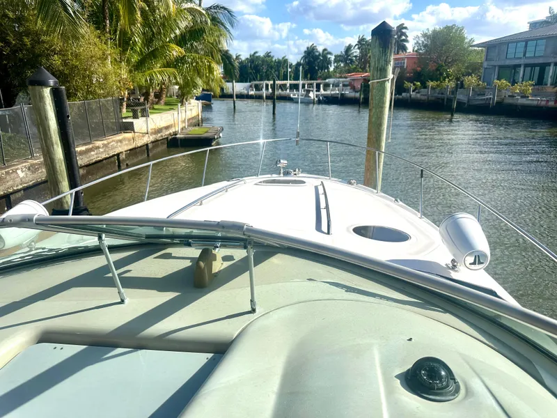 Slide: The Image of 2008 Sea Ray 420 Sundancer yacht docked in a scenic canal setting. - 16
