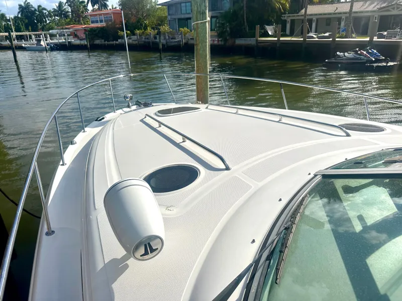 Slide: The Image of 2008 Sea Ray 420 Sundancer yacht docked by waterfront homes. - 19