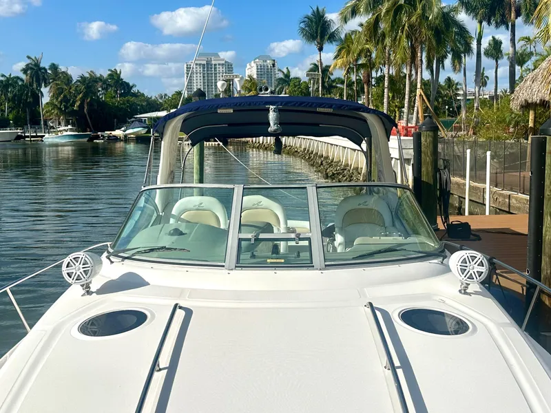 Slide: The Image of 2008 Sea Ray 420 Sundancer docked by palm trees and waterfront buildings. - 22