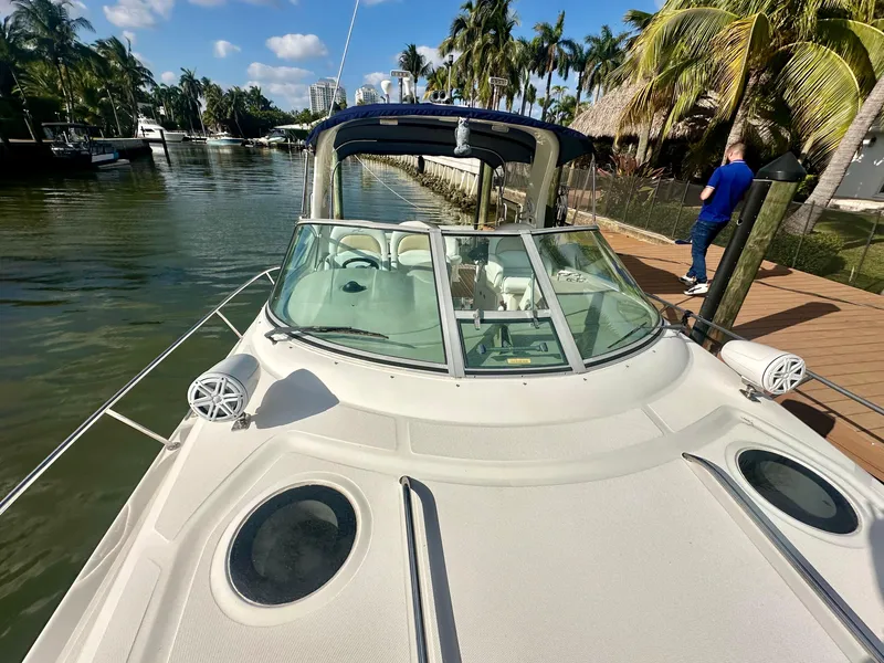 Slide: The Image of 2008 Sea Ray 420 Sundancer yacht docked by a tropical waterfront. - 23