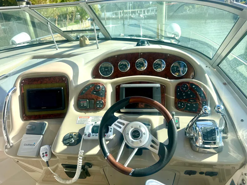 Slide: The Image of Helm of 2008 Sea Ray 420 Sundancer with modern navigation controls and wood-accented dashboard. - 28