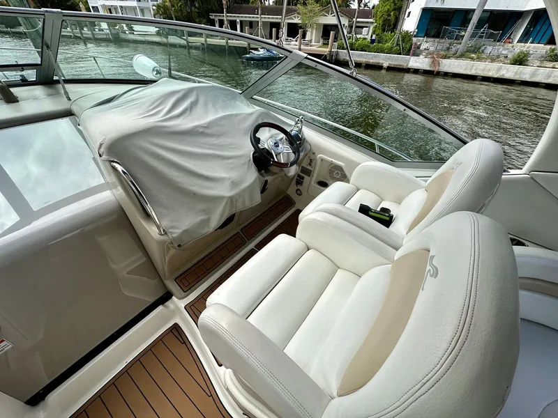 Slide: The Image of 2008 Sea Ray 340 Sundancer cockpit with covered steering wheel and plush seating. - 30