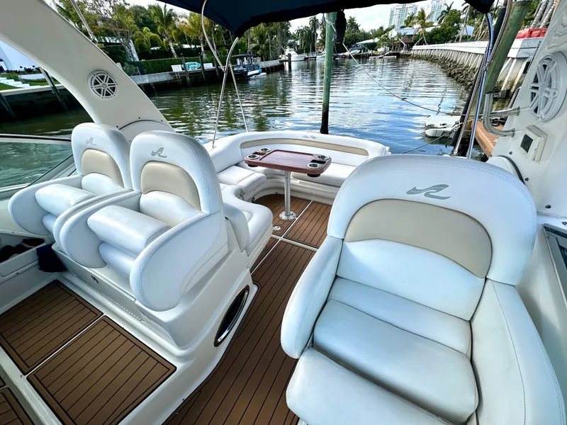 Slide: The Image of 2008 Sea Ray 420 Sundancer yacht interior with white seating and wooden deck. - 34