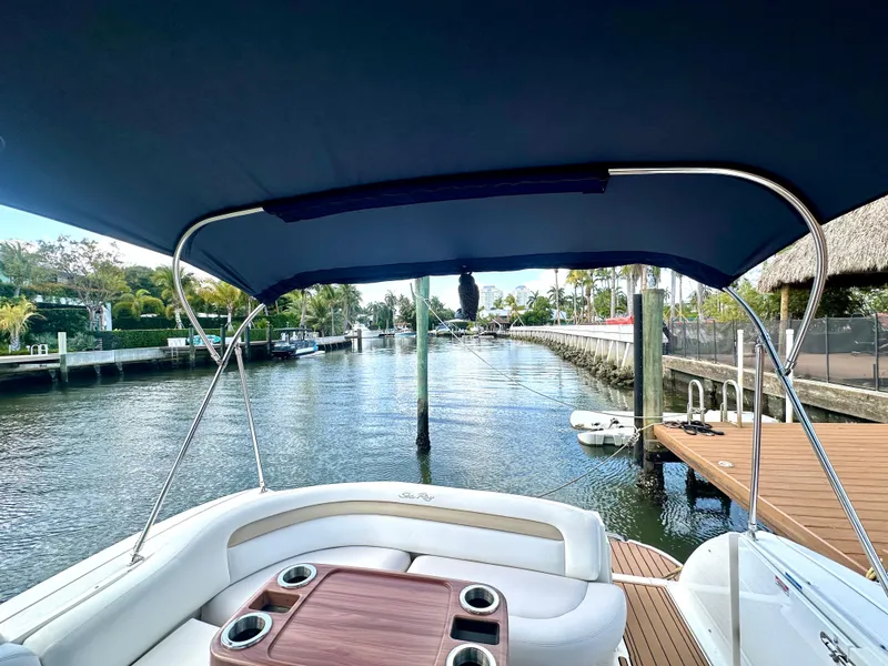 Slide: The Image of 2008 Sea Ray 420 Sundancer boat with canopy, docked by a scenic waterfront. - 37