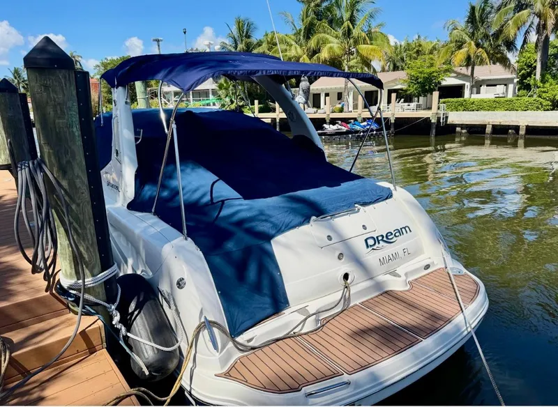 Slide: The Image of 2008 Sea Ray 340 Sundancer docked in Miami, covered with blue canopy. - 40