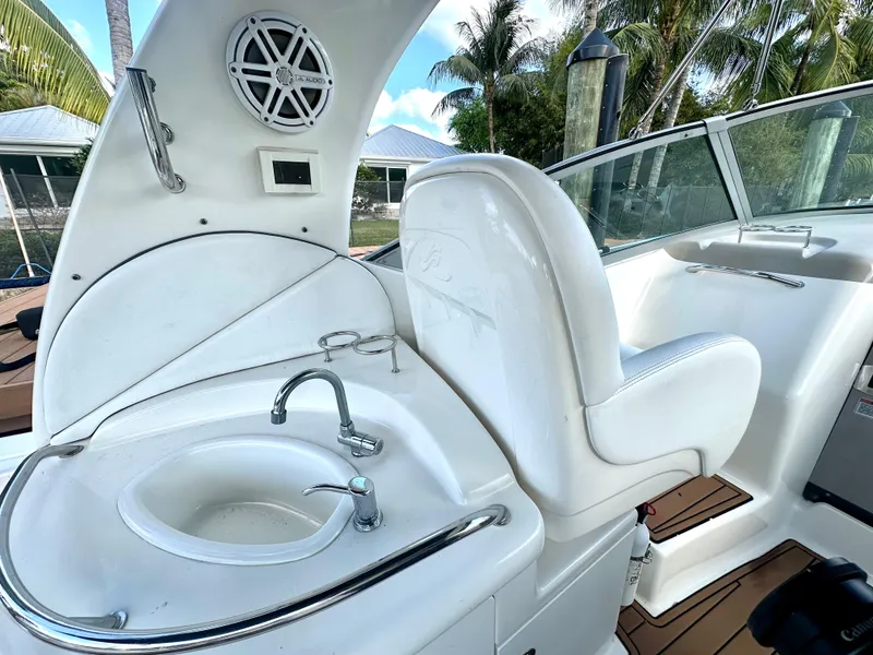 Slide: The Image of 2008 Sea Ray 420 Sundancer cockpit with sink and seating, featuring sleek white design. - 42
