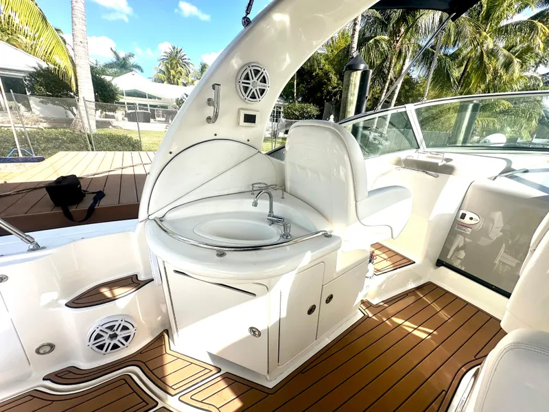 Slide: The Image of 2008 Sea Ray 420 Sundancer yacht interior with sink and seating, featuring teak flooring. - 43