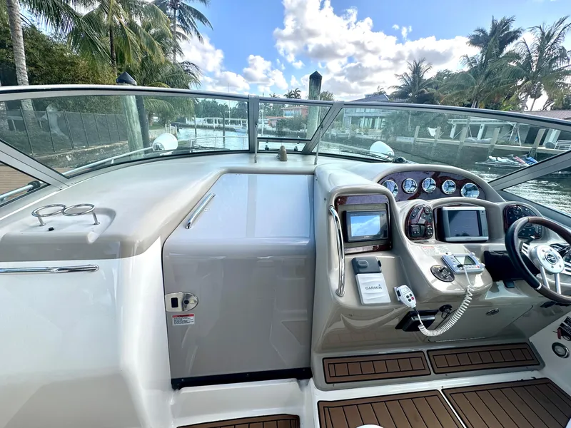 Slide: The Image of Helm of 2008 Sea Ray 420 Sundancer with navigation equipment and wooden deck. - 47