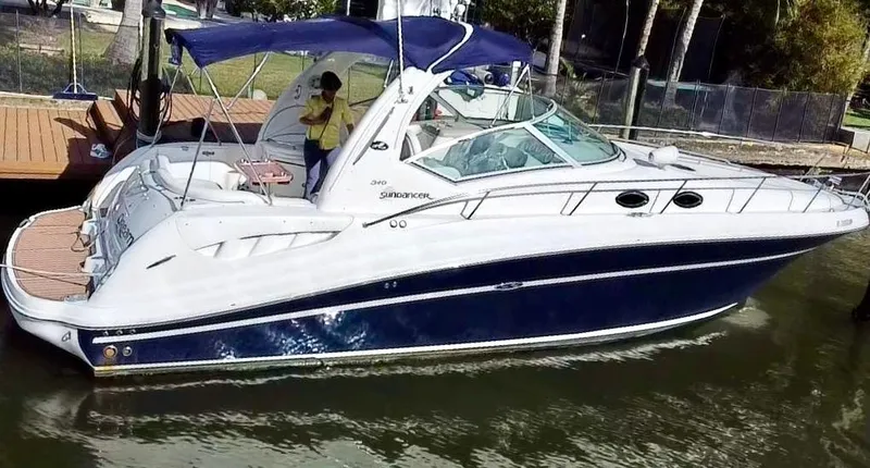 Slide: The Image of 2008 Sea Ray 420 Sundancer yacht docked, featuring sleek design and blue hull. - 5