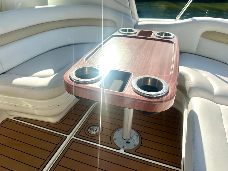 Slide: The Image of Luxurious seating area on 2008 Sea Ray 420 Sundancer with wooden table and cup holders. - 50