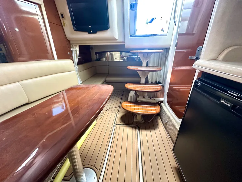 Slide: The Image of Interior of 2008 Sea Ray 420 Sundancer yacht with elegant seating and wooden table. - 54