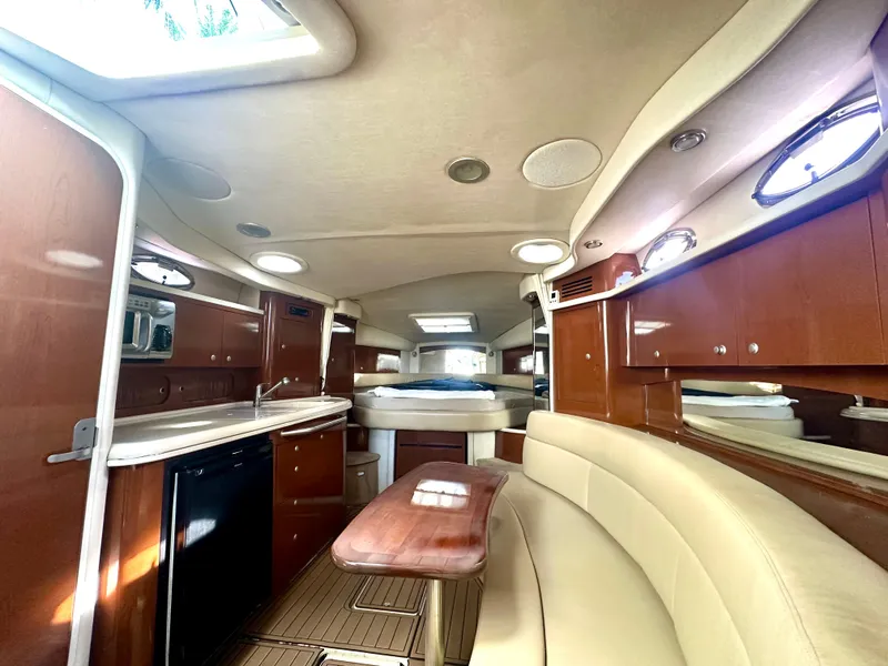 Slide: The Image of 2008 Sea Ray 340 Sundancer interior with elegant wood cabinetry and plush seating. - 59